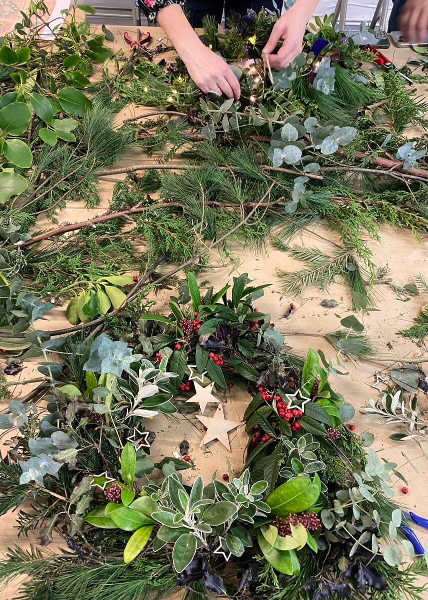Christmas wreath being made with fresh foliage at a Hove workshop