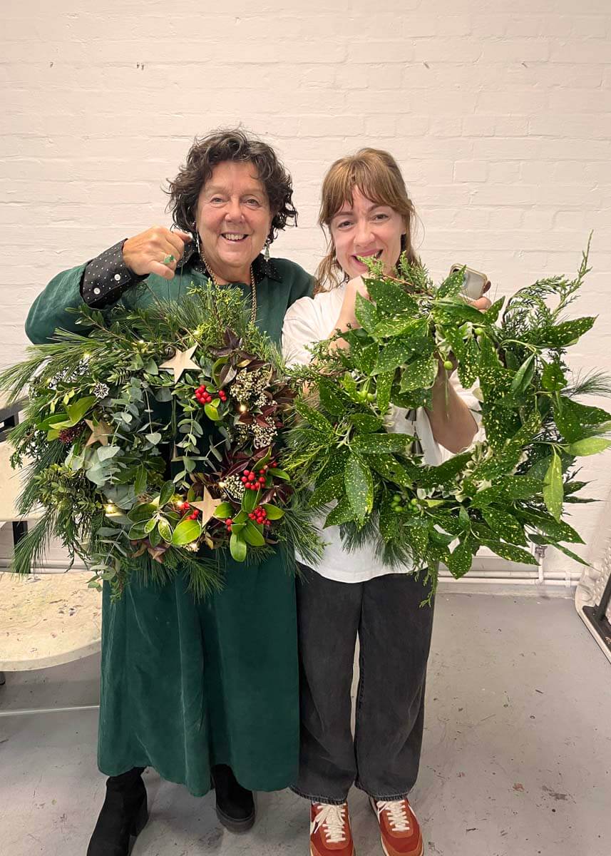 Happy customers with their finished Christmas wreaths in Hove
